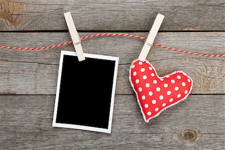 Blank instant photo and red heart hanging. On wooden background Stock Photo - Budget Royalty-Free & Subscription, Code: 400-07316768