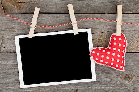 Blank instant photo and red heart hanging. On wooden background Stock Photo - Budget Royalty-Free & Subscription, Code: 400-07316770