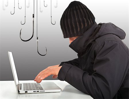 hacker working  with a laptop computer and hooks Stock Photo - Budget Royalty-Free & Subscription, Code: 400-07317492