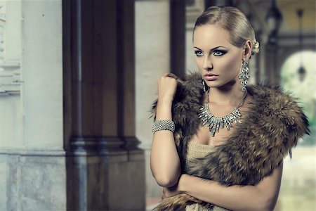 fashion portrait of luxury blond girl posing with elegant hair-style, fur shawl and precious shiny jewelery. Cute make-up Stock Photo - Budget Royalty-Free & Subscription, Code: 400-07317873