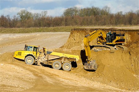 Yelloow truck and digger are working in mine Stock Photo - Budget Royalty-Free & Subscription, Code: 400-07319161