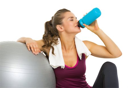 simsearch:400-05115517,k - Fitness young woman sitting near fitness ball and drinking water Stock Photo - Budget Royalty-Free & Subscription, Code: 400-07310101