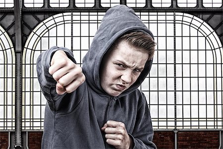 simsearch:400-06363059,k - Angry young boy throws a punch Stock Photo - Budget Royalty-Free & Subscription, Code: 400-07313481