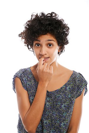 simsearch:400-05388090,k - Portrait of confused and uncertain hispanic woman biting nail on white background and looking at camera Stock Photo - Budget Royalty-Free & Subscription, Code: 400-07326351