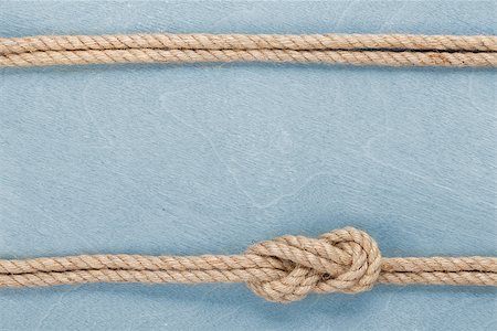 Ship rope knot on blue wooden texture background Stock Photo - Budget Royalty-Free & Subscription, Code: 400-07320196