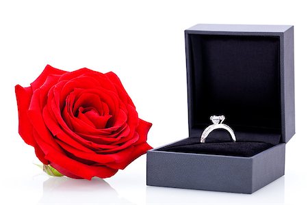 Engagement ring or Valentines gift for a sweetheart with a bunch of red roses signifying undying love on a white background Stock Photo - Budget Royalty-Free & Subscription, Code: 400-07323990