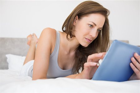 simsearch:400-06872329,k - Pretty relaxed young woman reading book in bed at home Stock Photo - Budget Royalty-Free & Subscription, Code: 400-07334045