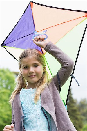 sky in kite alone pic - Portrait of a cute young girl with a kite standing outdoors Stock Photo - Budget Royalty-Free & Subscription, Code: 400-07336844