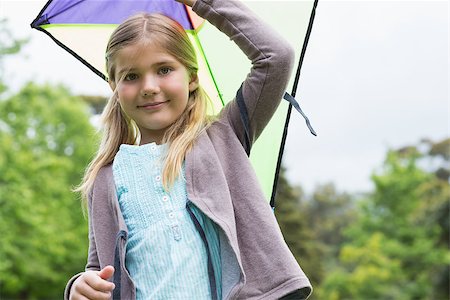 sky in kite alone pic - Portrait of a cute young girl with a kite standing outdoors Stock Photo - Budget Royalty-Free & Subscription, Code: 400-07336843