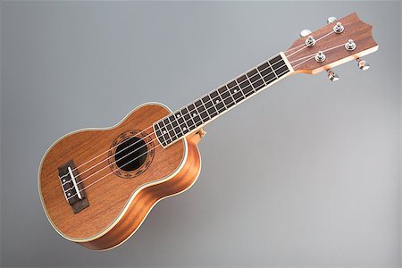 Studio shot of ukulele guitar on gray background Stock Photo - Budget Royalty-Free & Subscription, Code: 400-07338922