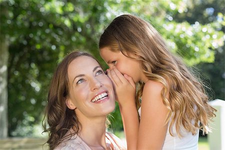 pictures of a little girl whispering - Close-up of a little young girl whispering secret into mother's ear at the park Stock Photo - Budget Royalty-Free & Subscription, Code: 400-07339698