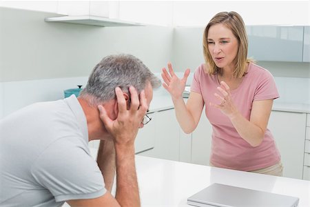 simsearch:6109-07601529,k - Unhappy couple having an argument in the kitchen at home Stock Photo - Budget Royalty-Free & Subscription, Code: 400-07339860