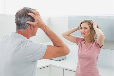 simsearch:6109-07601529,k - Unhappy couple having an argument in the kitchen at home Stock Photo - Budget Royalty-Free & Subscription, Code: 400-07339928