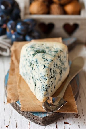 Delicious blue cheese with stilton spoon and fresh grape with walnuts on background. Stock Photo - Budget Royalty-Free & Subscription, Code: 400-07332557