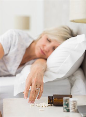 simsearch:693-03707745,k - Closeup of a mature woman sleeping in bed with pills in foreground at home Stock Photo - Budget Royalty-Free & Subscription, Code: 400-07333718