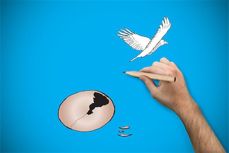 flying bird human hand - Hand holding a pencil against blue background with vignette Stock Photo - Budget Royalty-Free & Subscription, Code: 400-07347589