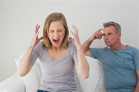 simsearch:6109-07601529,k - Unhappy couple having an argument in the living room at home Stock Photo - Budget Royalty-Free & Subscription, Code: 400-07340490