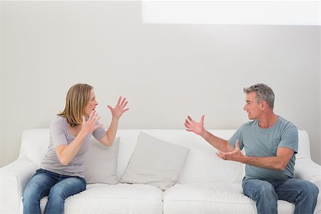 simsearch:400-07343634,k - Unhappy couple having an argument in the living room at home Stock Photo - Budget Royalty-Free & Subscription, Code: 400-07340506
