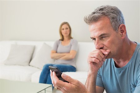 simsearch:400-07343634,k - Unhappy couple not talking after an argument in the living room at home Stock Photo - Budget Royalty-Free & Subscription, Code: 400-07340508