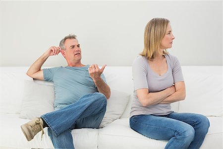 simsearch:400-07343634,k - Unhappy couple not talking after an argument in the living room at home Stock Photo - Budget Royalty-Free & Subscription, Code: 400-07340517