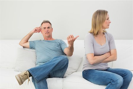 simsearch:400-07343634,k - Unhappy couple not talking after an argument in the living room at home Stock Photo - Budget Royalty-Free & Subscription, Code: 400-07340519