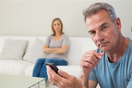 simsearch:400-07343634,k - Unhappy couple not talking after an argument in the living room at home Stock Photo - Budget Royalty-Free & Subscription, Code: 400-07340510