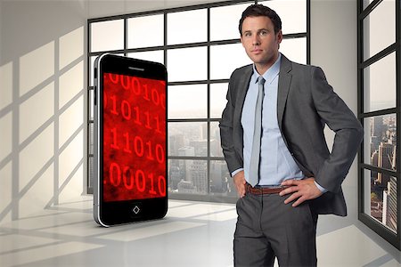 Serious businessman with hands on hips against room with large window showing city Stock Photo - Budget Royalty-Free & Subscription, Code: 400-07341347