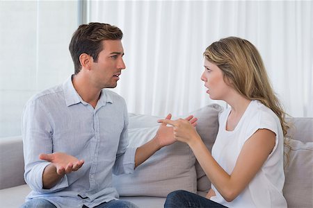 simsearch:400-07343634,k - Unhappy couple having an argument in living room at home Stock Photo - Budget Royalty-Free & Subscription, Code: 400-07343155
