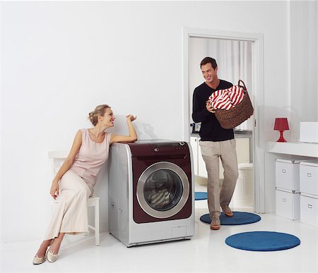 simsearch:400-08693600,k - Housework, young woman and man doing laundry Stock Photo - Budget Royalty-Free & Subscription, Code: 400-07406424