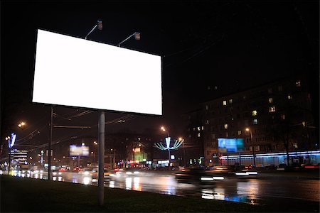 empty billboard advertising - Urban scene with an illuminated empty white billboard on the side of a street with cars in motion and a block of flats in the background, by night Stock Photo - Budget Royalty-Free & Subscription, Code: 400-07408436