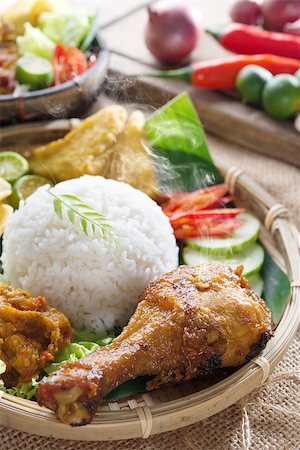 simsearch:400-07418409,k - Popular delicious Indonesian local food nasi ayam penyet, indonesian fried chicken rice with sambal belacan. Fresh hot with steam smoke. Stock Photo - Budget Royalty-Free & Subscription, Code: 400-07418404