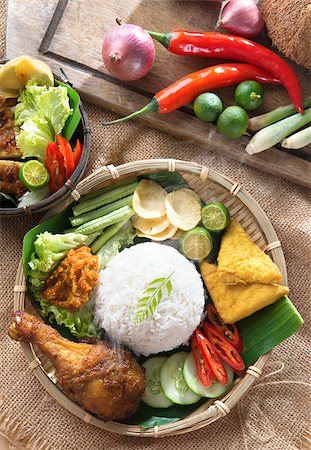 simsearch:400-07418409,k - Popular Indonesian local food nasi ayam penyet, indonesian fried chicken rice with sambal belacan. Fresh hot with steam smoke. Stock Photo - Budget Royalty-Free & Subscription, Code: 400-07418402