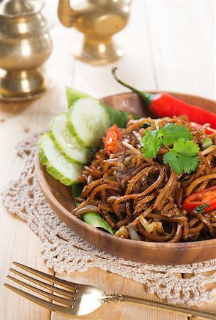 simsearch:400-07418409,k - Spicy fried noodles. Indonesian and Malaysian cuisine, mi goreng or mee goreng mamak with wooden dining table setting. Fresh hot with steamed smoke. Stock Photo - Budget Royalty-Free & Subscription, Code: 400-07418424