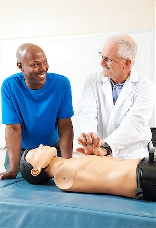simsearch:400-07411030,k - African-american adult student learning first aid CPR from a doctor. Stock Photo - Budget Royalty-Free & Subscription, Code: 400-07411019