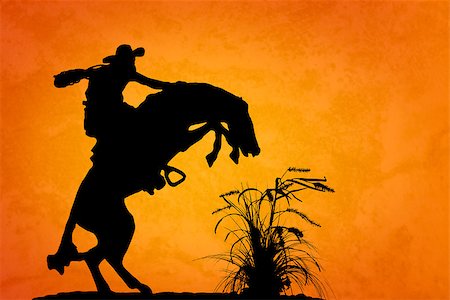 Silhouette of cowboy reigning bucking bronco spooked by something in the nearby sagebrush. Sunset orange/yellow textured background. Stock Photo - Budget Royalty-Free & Subscription, Code: 400-07412434