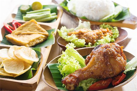 simsearch:400-07418409,k - Famous traditional Indonesian food. Delicious nasi ayam penyet with sambal belacan. Fresh hot with steam smoke. Stock Photo - Budget Royalty-Free & Subscription, Code: 400-07424739