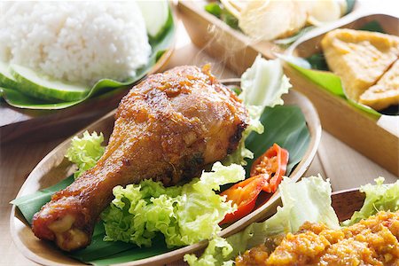 simsearch:400-07418409,k - Popular Indonesian local food nasi ayam penyet, indonesian fried chicken rice with sambal belacan. Fresh hot with steam smoke. Stock Photo - Budget Royalty-Free & Subscription, Code: 400-07424740