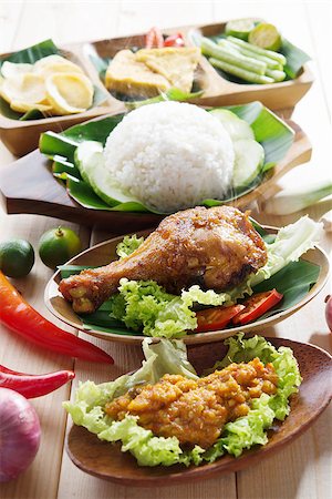 simsearch:400-07418409,k - Famous traditional Malay food. Delicious nasi ayam penyet with sambal belacan. Local flavor. Fresh hot with steam smoke. Stock Photo - Budget Royalty-Free & Subscription, Code: 400-07424741