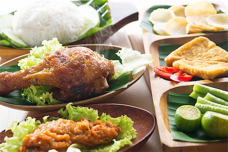 simsearch:400-07418409,k - Popular delicious Indonesian local food nasi ayam penyet, indonesian fried chicken rice with sambal belacan. Fresh hot with steam smoke. Stock Photo - Budget Royalty-Free & Subscription, Code: 400-07424743