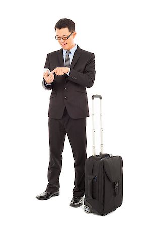 Young businessman using a cell phone  with briefcase Stock Photo - Budget Royalty-Free & Subscription, Code: 400-07425920