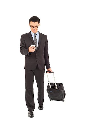 businessman walking and using phone  with briefcase Stock Photo - Budget Royalty-Free & Subscription, Code: 400-07427456