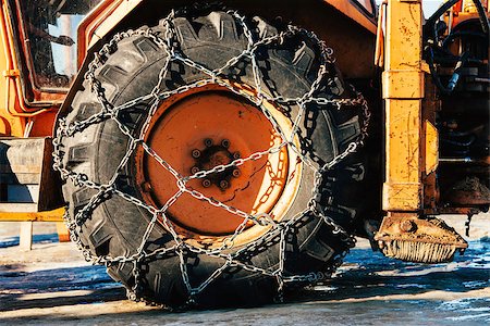 simsearch:400-07215754,k - Snow chains outside of a tractor tire - winter transportation imagewinter Stock Photo - Budget Royalty-Free & Subscription, Code: 400-07429717