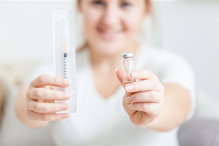 patient injection arm not children - Photo of young woman holding syringe Stock Photo - Budget Royalty-Free & Subscription, Code: 400-07421341