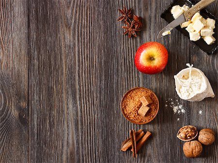 Ingredients for apple pie cooking. Fresh red apple, butter, flour, brown sugar, nuts and spices on a rustic wooden background. Stock Photo - Budget Royalty-Free & Subscription, Code: 400-07445508