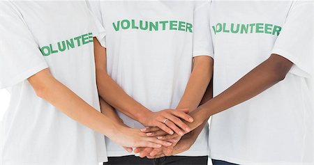 Team of volunteers putting hands together on white background Stock Photo - Budget Royalty-Free & Subscription, Code: 400-07467188