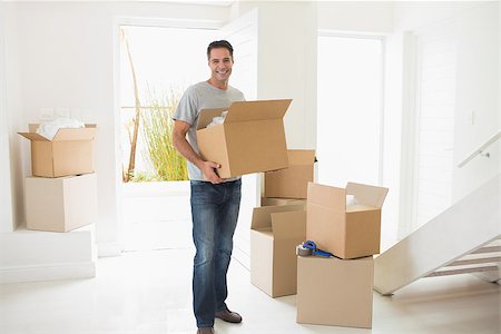 simsearch:400-07930718,k - Portrait of a smiling man carrying boxes in a new house Stock Photo - Budget Royalty-Free & Subscription, Code: 400-07467842