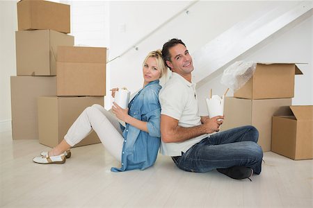 simsearch:400-07930718,k - Side view portrait of a smiling couple with takeaway food in a new house Stock Photo - Budget Royalty-Free & Subscription, Code: 400-07467856