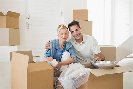 simsearch:400-07930718,k - Portrait of a smiling couple unpacking boxes in a new house Stock Photo - Budget Royalty-Free & Subscription, Code: 400-07467851