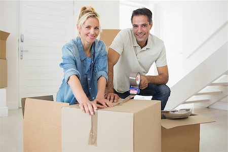 simsearch:400-07930718,k - Portrait of a smiling couple packing boxes in a new house Stock Photo - Budget Royalty-Free & Subscription, Code: 400-07467852