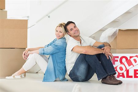 simsearch:400-07930718,k - Side view portrait of a smiling couple with boxes in a new house Stock Photo - Budget Royalty-Free & Subscription, Code: 400-07467868